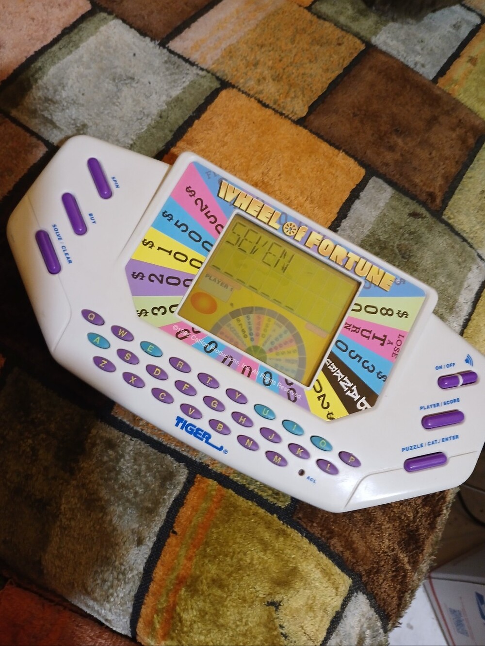 Tiger Electronics Wheel of Fortune Handheld Game - White with Purple Keys